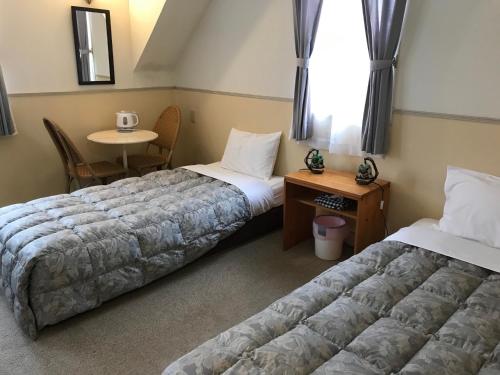 Ένα ή περισσότερα κρεβάτια σε δωμάτιο στο Petit Hotel Kurumi to Milk