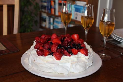 a cake with strawberries and whipped cream and two glasses of champagne at The Summit Lodge in Gladstone