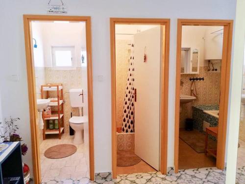 a bathroom with a toilet and a sink at Puntin Rooms Sobe in Korčula
