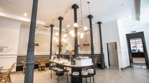a restaurant with a table and chairs in a room at Soho Boutique Opera in Madrid