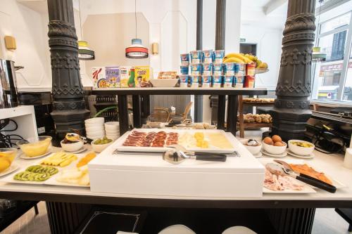 a table with different types of food on it at Soho Boutique Opera in Madrid