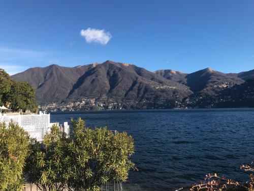 a view of a lake with mountains in the background at Carate 16 apartment with balcony & lake view in Carate Urio