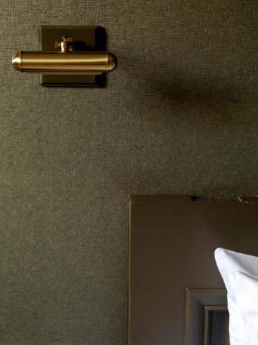 a gold towel holder on a wall next to a door at Boutique hotel Sint Jacob in Maastricht