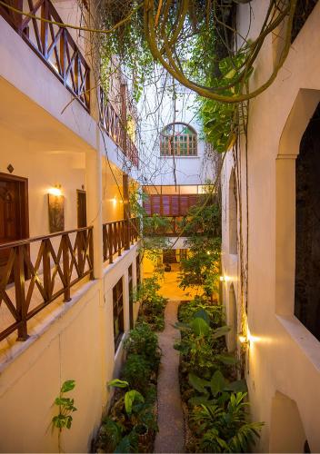 an indoor garden in a building with a glass ceiling at The Seyyida Hotel and Spa in Zanzibar City