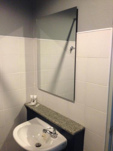 a bathroom with a sink and a mirror at Chalong Sea Breeze in Chalong 