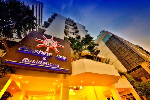 a building with a sign on the side of it at Sunshine Hotel & Residences in Pattaya Central