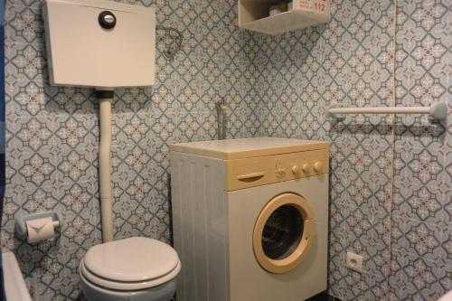 a small bathroom with a washing machine in it at Porto Fontainhas, by Flat in Porto in Porto