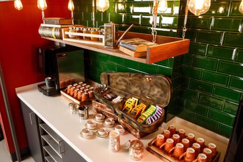 a counter with a bunch of different types of food at ibis Styles London Southwark - near Borough Market in London