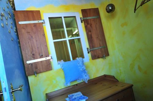 a room with two windows and a wooden table at Hotel Goldflair am Rathaus in Korbach