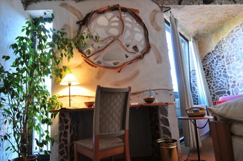 a room with a chair and a table and a lamp at Hotel Goldflair am Rathaus in Korbach