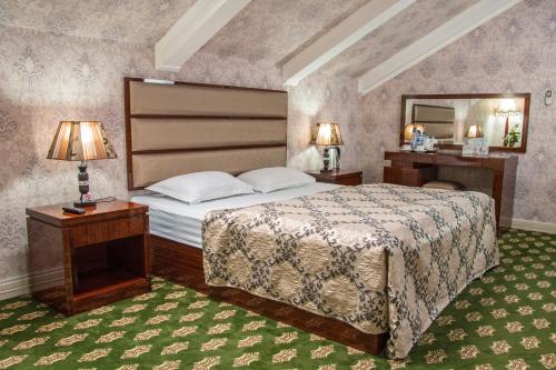 a bedroom with a large bed and a mirror at City Line Boutique Hotel in Tashkent