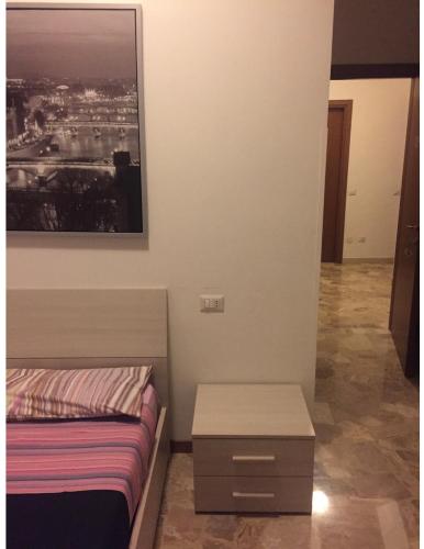 a small bedroom with a bed and a night stand at Ca’Melia B&B in Arconate