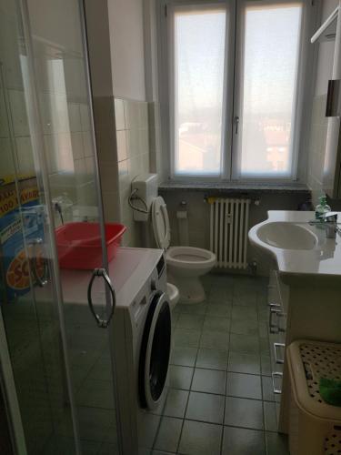 a bathroom with a shower and a toilet and a sink at De Candia House in Rescaldina