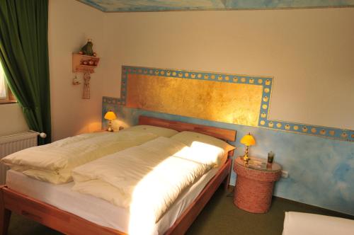 a bedroom with a bed with lights on it at Hotel Goldflair am Rathaus in Korbach