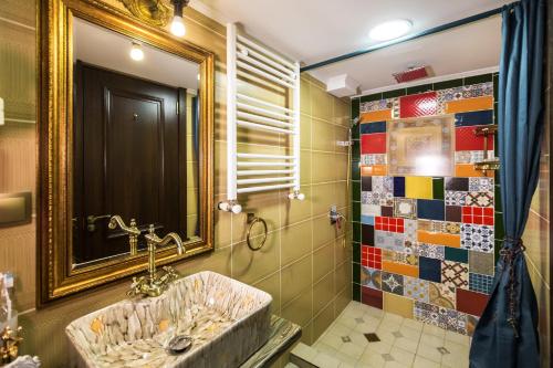 a bathroom with a sink and a mirror at Tiflis Inn Boutique Hotel in Tbilisi City