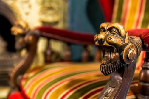 a wooden bench with a lion head on it at Tiflis Inn Boutique Hotel in Tbilisi City