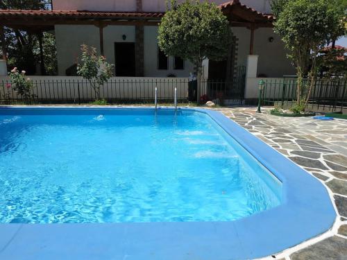 a swimming pool with blue water in a yard at Ancient Olympia Luxury Pool Villa Palace 4Bedroom in Olympia