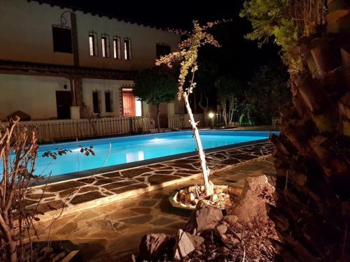 a swimming pool in front of a house at night at Ancient Olympia Luxury Pool Villa Palace 4Bedroom in Olympia
