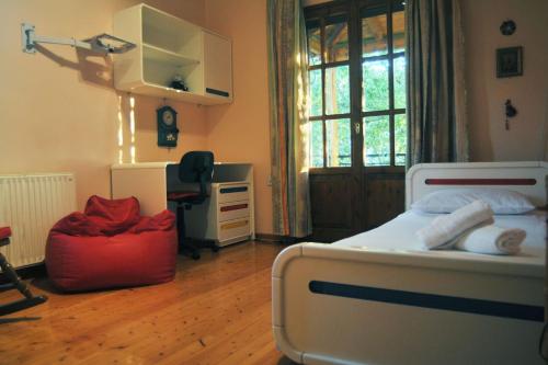 a bedroom with a bed and a desk and a window at Ancient Olympia Luxury Pool Villa Palace 4Bedroom in Olympia