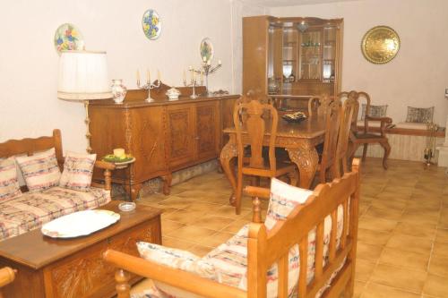 a living room with a couch and a table and chairs at Ancient Olympia Luxury Pool Villa Palace 4Bedroom in Olympia
