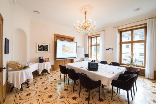 a meeting room with a long table and chairs at Gast - und Kulturhaus Der Teufelhof Basel in Basel