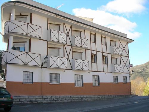 a building with metal balconies on the side of it at Apartamentos Duquesa Sierra Nevada in Pinos Genil