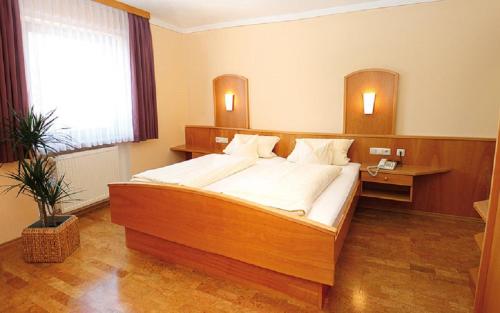 um quarto com uma cama grande num quarto em Appartementhaus Safferstetten em Bad Füssing