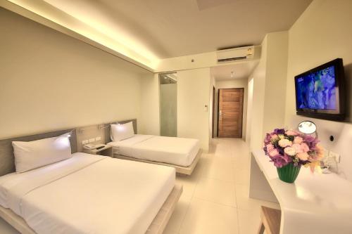 Ένα ή περισσότερα κρεβάτια σε δωμάτιο στο Sunshine Hotel & Residences