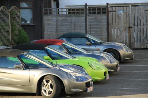 a row of parked cars parked in a parking lot at Annandale Arms Hotel in Moffat