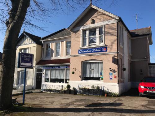 a building with a car parked in front of it at Crimdon Dene in Torquay