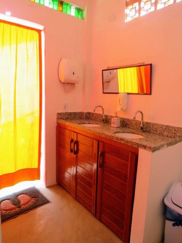 a bathroom with a sink and a mirror at Tribo de Gaia in Itaúnas