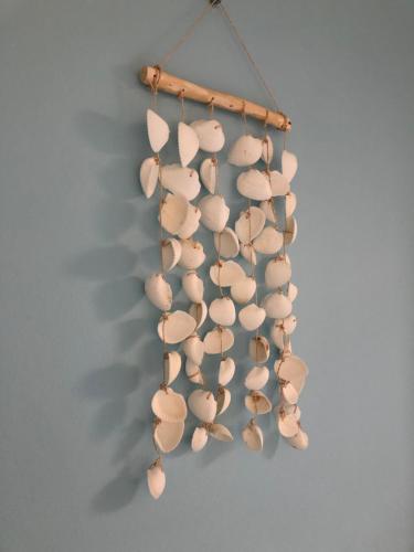 un montón de conchas colgando de una pared en Kingstreet Cottage, en Zandvoort