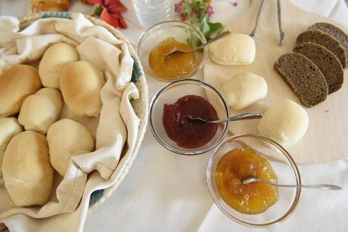 a table topped with bowls of bread and dipping sauces at Baja Azzurra in Bari Sardo
