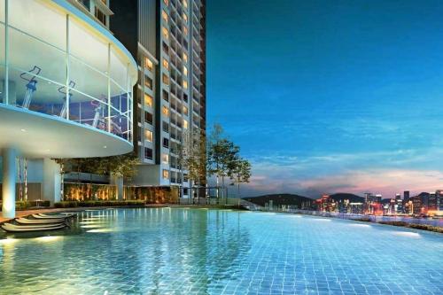 a large swimming pool on the side of a building at Mevin Woodsbury Home Butterworth Penang in Butterworth