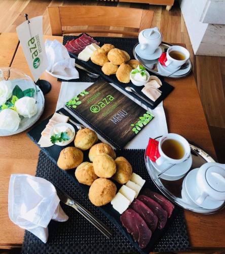a table with two trays of food and cups of coffee at Villas and apartments Oaza in Sarajevo