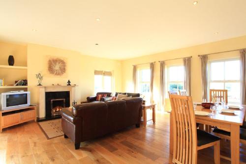 a living room with a couch and a table and a television at Barr Cill Atha in Kenmare