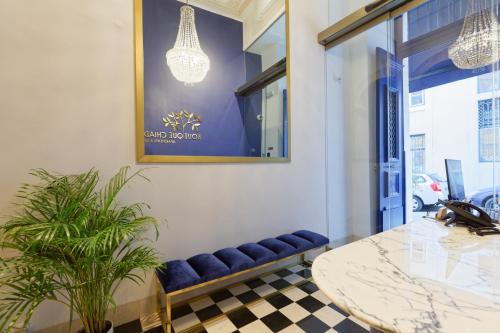 a room with a table, chairs, and a lamp at Boutique Chiado Suites in Lisbon