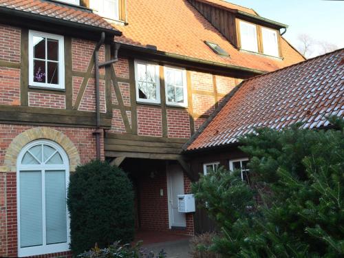 a red brick house with a white door and windows at Ferienwohnung Johns in Bad Bevensen