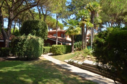 ビビオーネにあるVillaggio Euro Residence Clubの樹木や茂みのある庭のある家