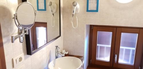 a bathroom with a sink and a mirror at Casa Lady in Garda
