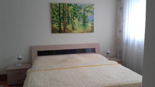 a bedroom with a bed and a painting on the wall at Ferienwohnung Bea in Rheine in Rheine