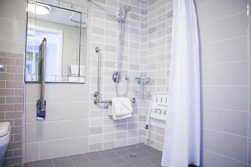 a bathroom with a shower with a white shower curtain at Gleneagle Killarney in Killarney