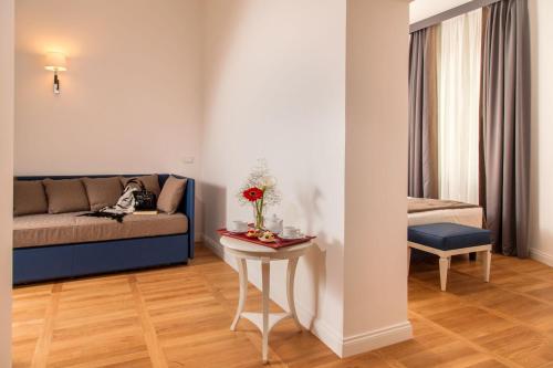a living room with a couch and a table at Floris Hotel in Rome