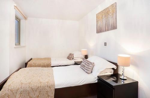 a bedroom with a bed and a table with a lamp at 16 John Walker House in York