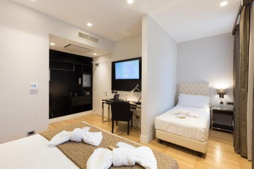 a bedroom with a bed and a desk in a room at Floris Hotel in Rome