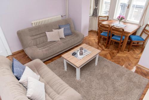 a living room with a couch and a table at Sweet House Trg in Belgrade