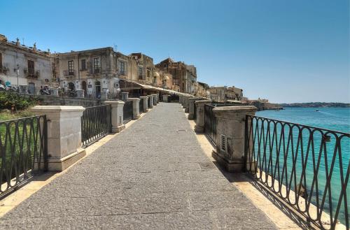 a bridge over a body of water with buildings at Apollo B&B in Siracusa