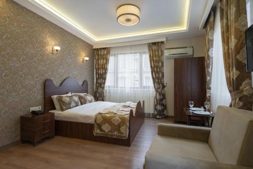 a hotel room with a bed and a couch at Capricorn by Otantik Suites in Istanbul
