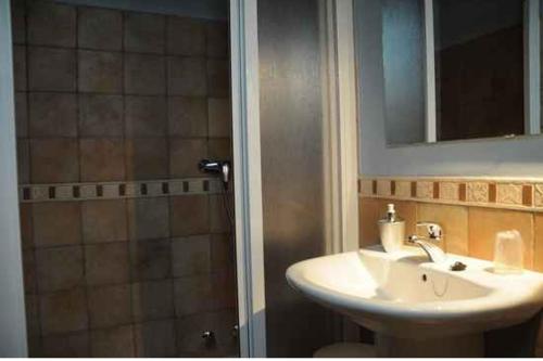 a bathroom with a sink and a shower with a mirror at Borda Felices in Broto
