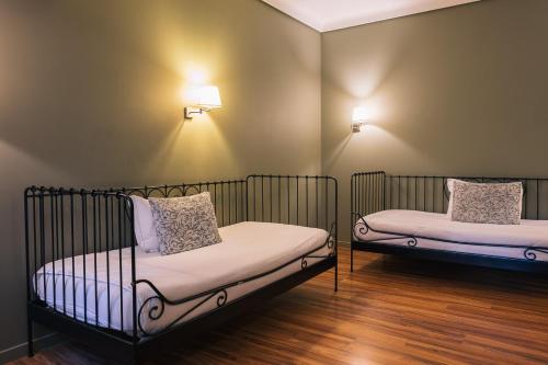 En eller flere senger på et rom på Hotel Sao Jose